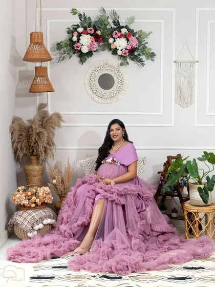 A full view of the boho setup with a beautiful mama-to-be in a lavender ruffled gown. The combination of colors and textures is simply dreamy.