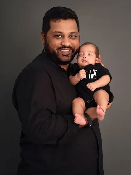A proud father holds his newborn son. This simple, classic portrait captures the powerful bond between a dad and his baby in those very first weeks.