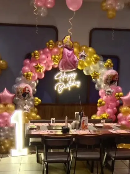 The full view of the princess party table setup, including the backdrop and a light-up number '1'.