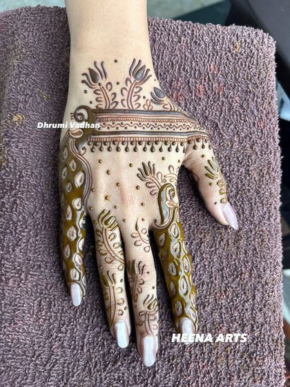 A contemporary back-hand design with a focus on negative space, featuring elegant peacock-inspired finger details.