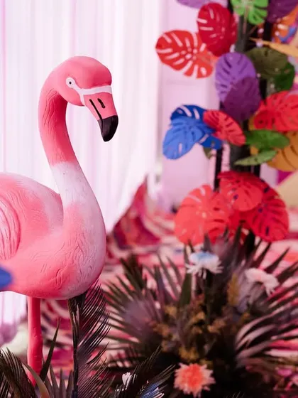 A pink flamingo statue, part of a tropical-themed Mehendi decor. It's the small, quirky details that make an event memorable.