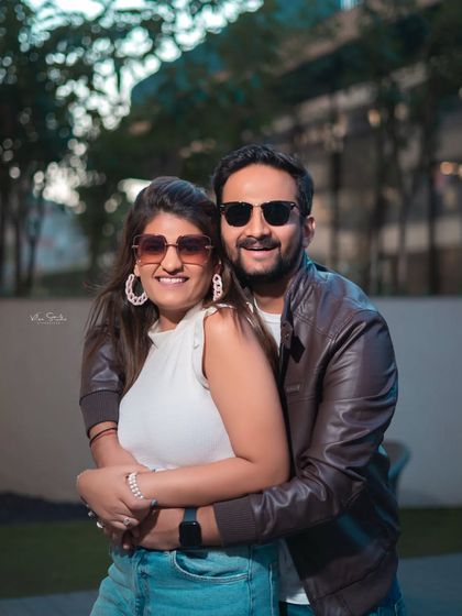 A happy, smiling portrait that radiates warmth and affection. The casual outfits and natural embrace make this a relatable and heartwarming couple photo.
