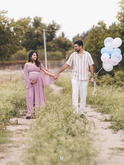 Walking hand-in-hand towards their future. This shot, with the couple walking along a country path holding balloons, creates a sense of journey and shared adventure.