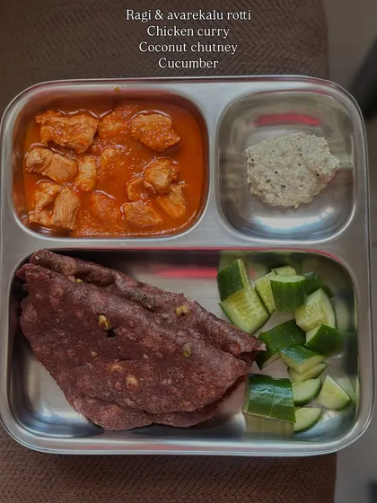 A variation with ragi and avarekalu roti served with chicken curry, coconut chutney, and cucumber. This meal is rich in calcium, iron, and protein.