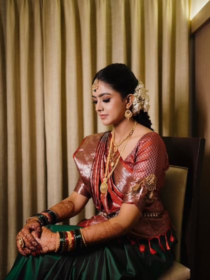 A moment of quiet reflection, showcasing the soft glam makeup and the rich textures of her Kanjeevaram saree.
