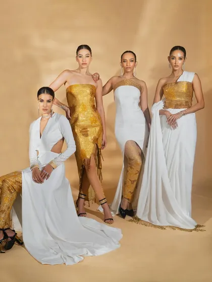 A group photograph for Nikhil Thampi's 'Ivory Edit'. This shot brings together four models in white and gold outfits, demonstrating the collection's theme and variety of styles.