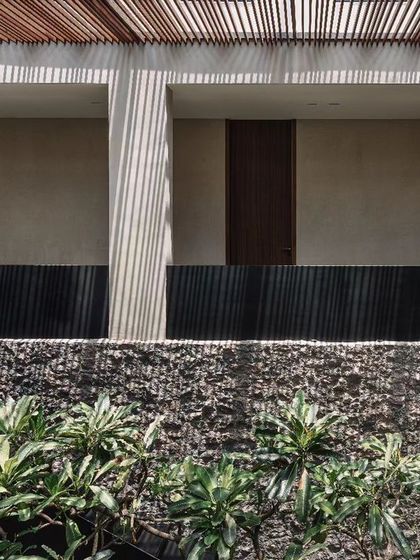 An architectural detail of the upper-level balconies overlooking the courtyard. The design uses simple, repeating forms to create a sense of rhythm and order.