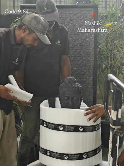 A 3-foot black marble Buddha statue being carefully wrapped in protective foam before being placed in its crate for shipment to Nashik.