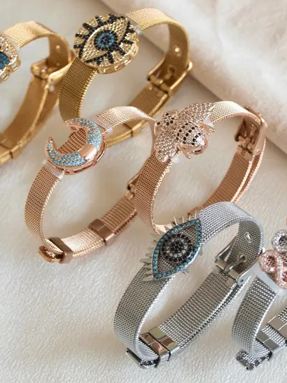 Fun for your wrist. Our watch belt bracelets are a playful way to accessorize, featuring charms like the evil eye, moon, and butterfly. They are available in gold, rose gold, and silver tones.