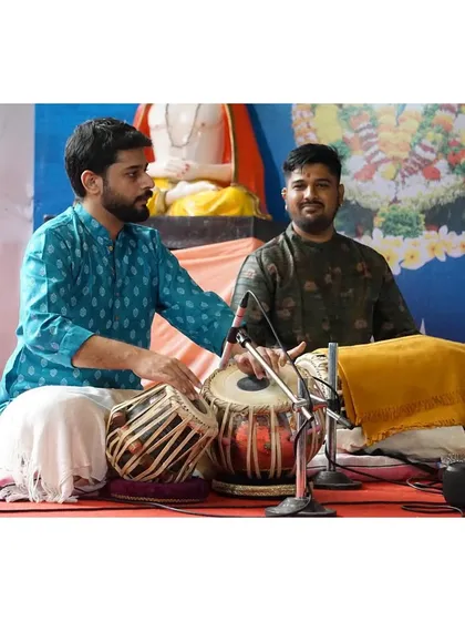 In conversation with a fellow musician on stage at the Alandi music festival.