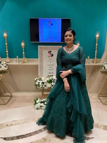 My happy client looks absolutely beautiful in this emerald green gown with ruffled details. It's a great example of finding the perfect color and style for your event.