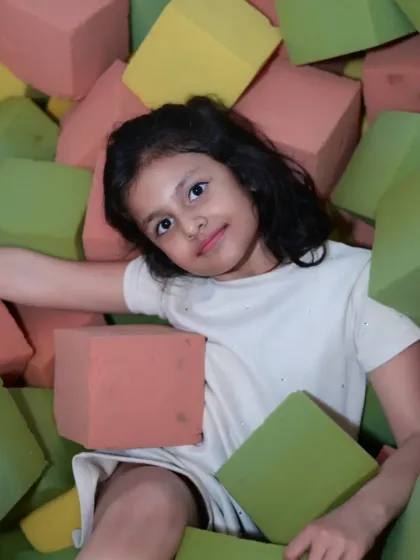 Another happy guest enjoying the foam block pit. This area encourages creative building and imaginative play.