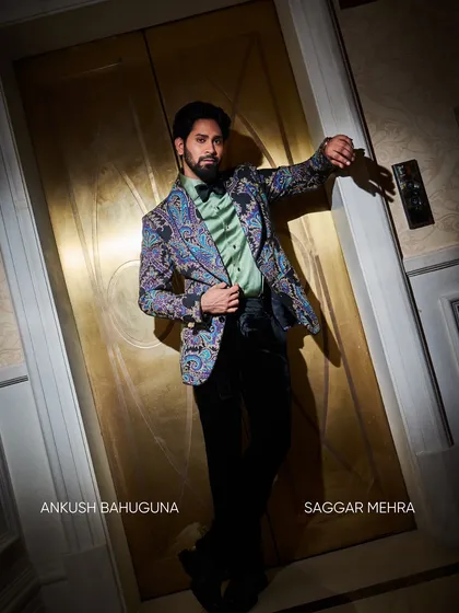 Styled with a bow tie and a mint green shirt, the printed jacket takes on a more formal, eclectic feel. It demonstrates how a single statement piece can be adapted for different occasions.