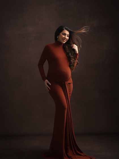 The wind in her hair adds a touch of dynamic energy to this beautiful solo portrait, showcasing the flowing fabric of the earthy-toned gown.