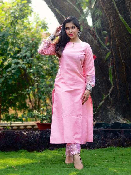 This classic pink silk kurta set is a perfect example of simple elegance. The embroidered organza detail on the sleeves adds a delicate, luxurious touch to an otherwise simple silhouette.