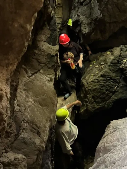 Navigating through a narrow passage during our caving adventure. These challenges are a great way to build confidence and discover your own resilience.