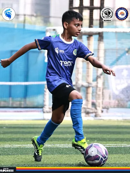 A player dribbles with his head up, scanning the field for options. We teach smart, tactical football.