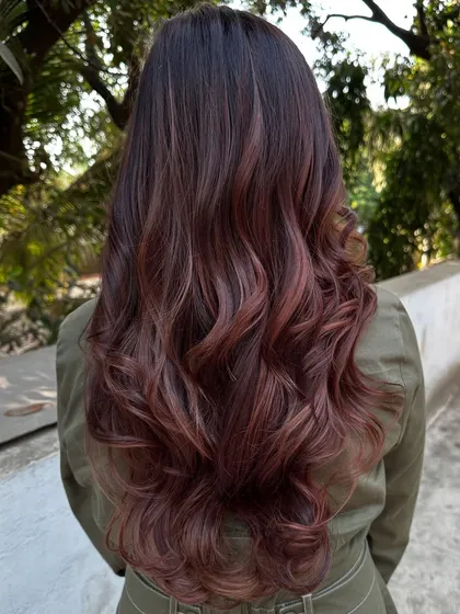 A 'Rose Gold' dream come true. We transformed her faded highlights into this stunning metallic pink shade. It’s a trendy yet sophisticated way to play with color.