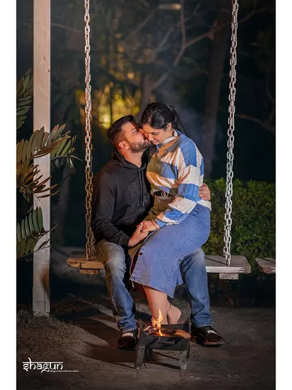 A casual, sweet moment on a swing by a small bonfire. This photo shows that even simple props can create a warm, cozy, and deeply personal pre-wedding memory.
