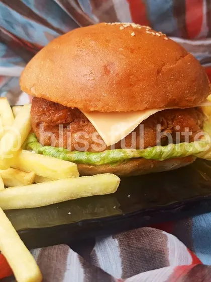 The complete Chicken Zinger Burger meal. The combination of the crispy burger and salty fries is a guaranteed crowd-pleaser for any event.