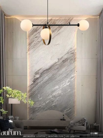 A minimalist masterpiece, this linear pendant features three globe lights, one of which is accented with a brass ring. It's a sculptural piece that doubles as art, perfect for highlighting an architectural feature wall.