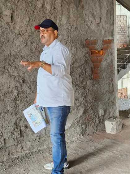 Holding a Vastu plan while explaining the corrections needed for a specific wall at a construction site. My reports are detailed and actionable.
