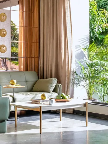 Here at the Tranquil Mango Haven, the living area extends directly into the front garden. Large windows frame the vibrant bamboo and greenery, making the landscape an integral part of the interior experience and creating a single, continuous space.