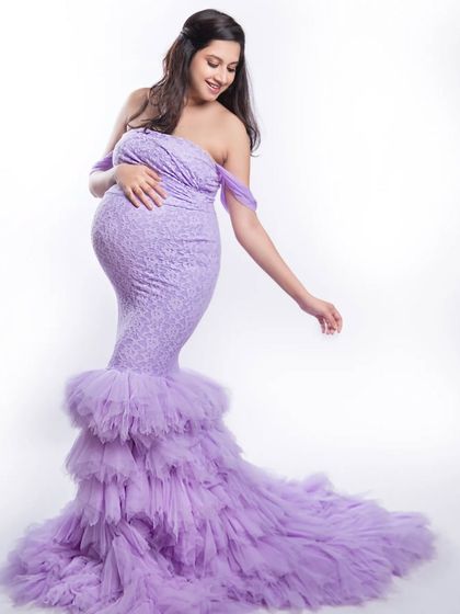 Straight out of a fairytale. This gorgeous lavender mermaid-style gown with a ruffled train is perfect for creating a dreamy and unforgettable maternity portrait.