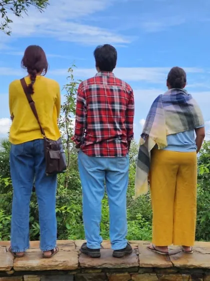 A group of participants taking a moment to admire the valley view together. Shared silence is as much a part of the community experience as shared stories.