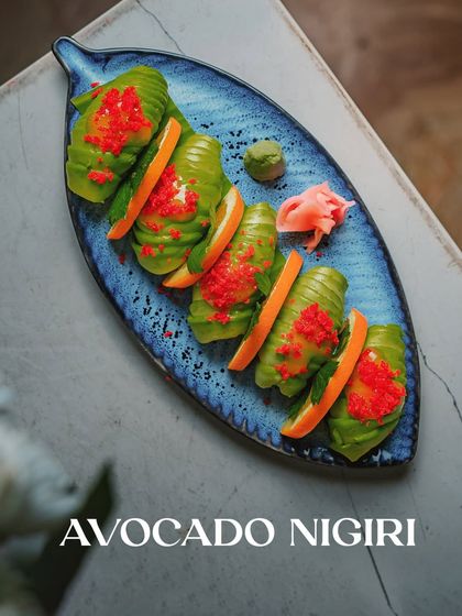 Our Avocado Nigiri, a vegetarian delight. Creamy avocado is draped over seasoned rice, offering a clean, fresh, and satisfying bite.