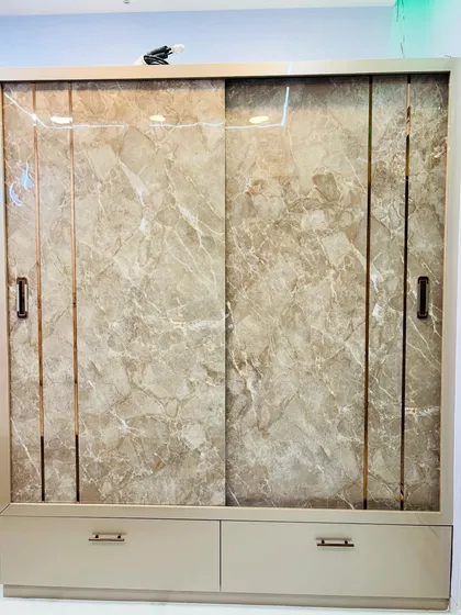 A frontal view of the two-door sliding wardrobe with a marble finish.