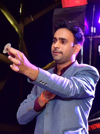 Performing a classic coin trick. Simple props can create the most profound moments of astonishment.
