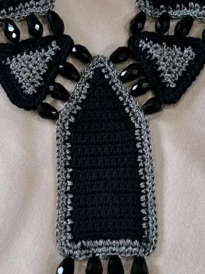 A detail shot of the pendant portion of our custom-made necklace. The combination of crochet, zari, and beads showcases the multi-material artistry we love to explore.