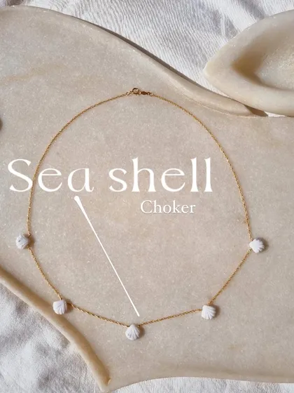 Another view of my howlite sea shell choker. The tiny, hand-carved shells are a reminder of the ocean's peaceful rhythm.