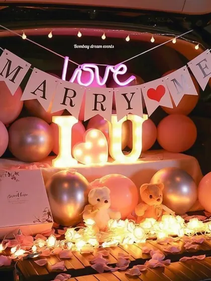 A sweet and romantic car boot decor setup with 'I Love U' marquee letters, teddy bears, and soft pink balloons.