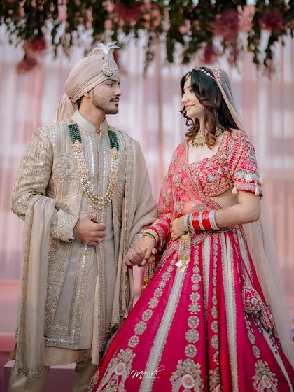 A classic couple portrait after the ceremony, holding hands and looking at each other with love and promise for the future.