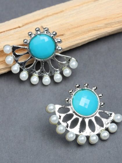 Our half-moon shaped studs in silver tone with a bright turquoise stone and pearl details.