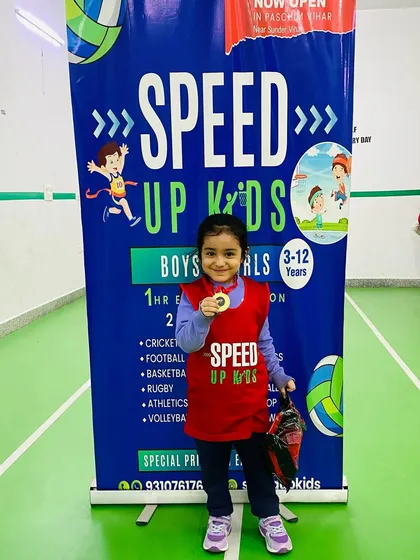 A solo shot of Nyra with her medal and prize. She has shown great progress and dedication.