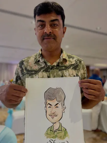 Capturing the likeness of a guest at a wedding reception. Each portrait is drawn live in minutes, providing entertainment and a unique takeaway.