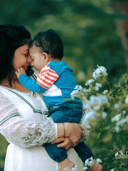 An intimate moment between a mother and her child during an outdoor lifestyle session, capturing their quiet, loving connection.