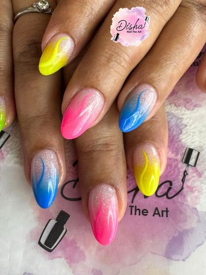Why choose one color when you can have them all? This vibrant set features a different neon color on each nail with a flame-like design.