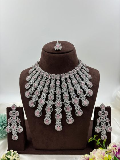 A magnificent, full-coverage AD necklace set designed for grand events. The intricate web of American Diamonds creates a dazzling effect, perfect for bridal and reception wear.