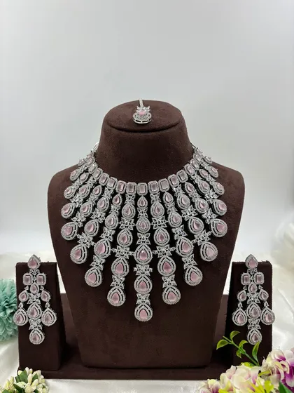 The full pink stone cascading AD necklace set on a display bust.