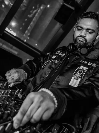 A detailed black and white shot of my hands on the mixer. This highlights the technical skill and craftsmanship involved in DJing.