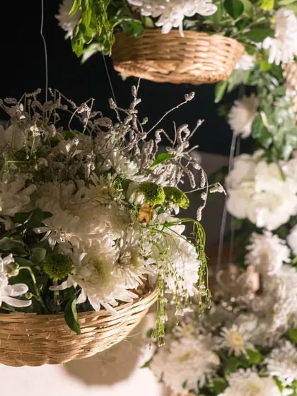 The combination of wicker baskets and lush white chrysanthemums adds a rustic yet chic touch to the event decor. I can arrange for a variety of floral styles to match your theme.