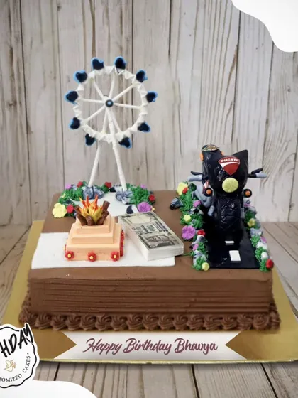 A manifestation cake for someone with big dreams. This unique design features a Ducati bike, money, the London Eye, and a sacred fire, representing all of Bhavya's goals.