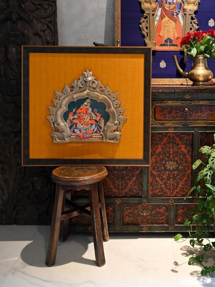 The smaller of the two family heirlooms, this vintage Prabhavali now frames a Tanjore-style Ganesha. I chose a warm, marigold-colored textured fabric to complement the artwork and the aged brass of the frame.