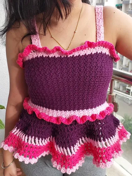 This is the Azores Top, a playful peplum design with ruffled details. I used a vibrant purple and pink color combination here, but we can choose any colors you love.