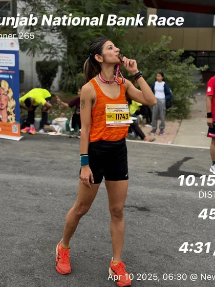 After a 10km race, tasting the medal. Every finish line is a victory. This was the Punjab National Bank Race, a great local event.