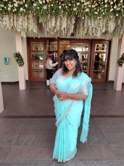Posing at the entrance of the event venue. The floral decor perfectly complemented my light blue saree.